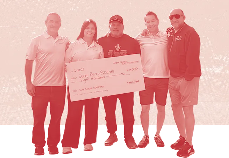 Danny Berry and the DGFF team stand together, presenting an $8,000 check funding youth sports scholarships.